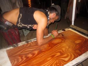 Live oil stain painting by Visionary Artist Darren Minke near Lucid Stage